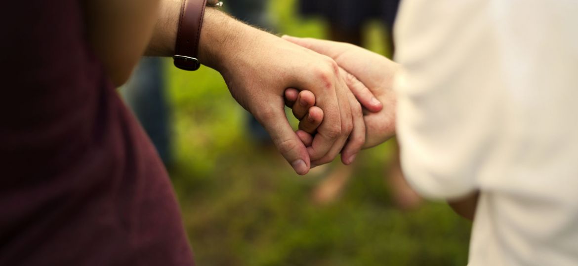 Group of people support unity arm around together